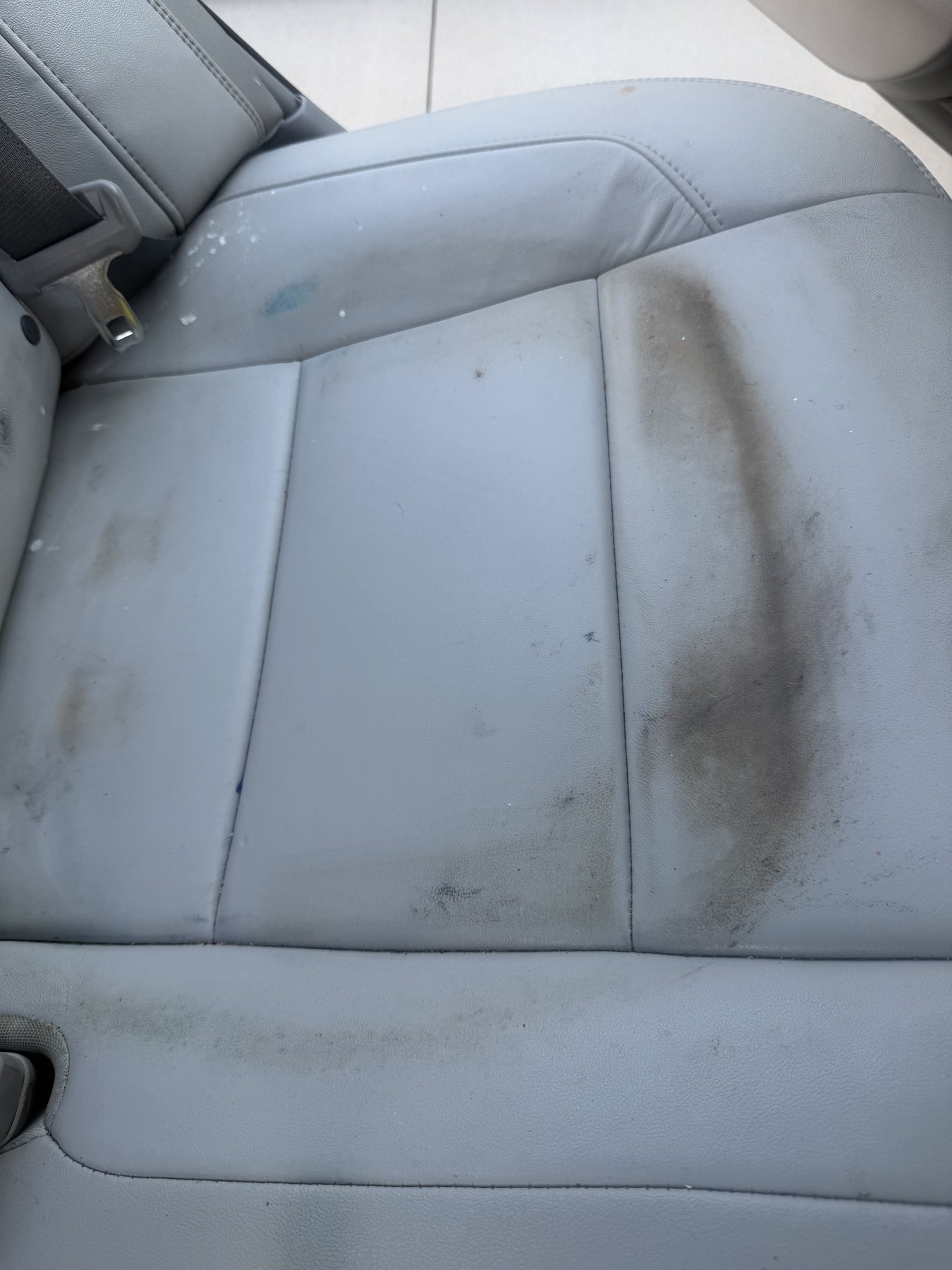 Stained white leather seat before detailing